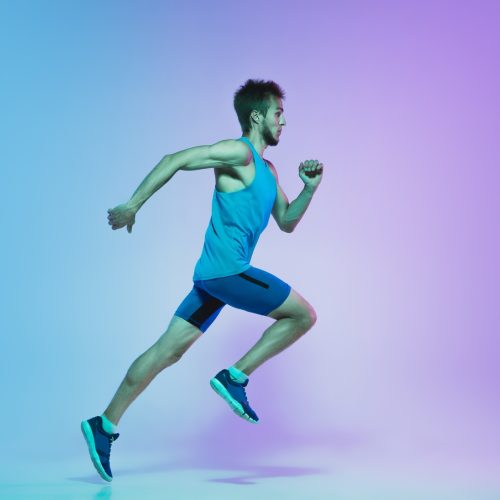 full-length-portrait-active-young-caucasian-running-jogging-man-gradient-studio-neon-light.jpg